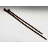 A lignum vitae cane, with turned knop, together with a further cane with carved finial, length