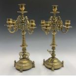 A pair of 19th century four branch brass candelabra, on ring turned taper columns and circular