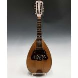 An Indian eight string mandolin, labelled for Braganza & Co, Calcutta, length of back 32cm, together