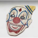 A clown head painted on wood. 52cm x 35cm (irregular).