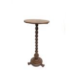 A Victorian walnut circular occasional table, with dished top on a barley twist support, circular