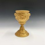 A gold painted spelter chalice cast with dolphin masks, floral sprays, putto etc. Height 27.5cm.