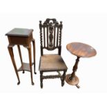 A Victorian carved oak side chair, a Victorian mahogany tripod table and a mahogany plant stand.