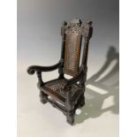 An extremely rare William and Mary, walnut miniature chair with foliate and swag carved top rail,