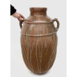 A large terracotta olive jar with twin handles. Height 83cm.