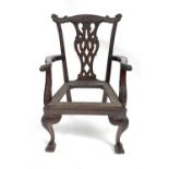 A George III style mahogany carver chair, with leaf and scroll carved ornate back and similar