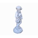 A lead garden statue of a boy holding grapes, on stone base. Height 85cm.