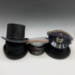 A bowler hat, labelled for Simpson Brothers Ltd, Penzance, another bowler hat, a top hat, also