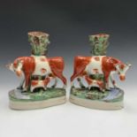 A pair of late Victorian Staffordshire cow and calf spill vases, height 27cm.Condition report: One