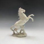 A Karl Ens porcelain model of a rearing horse, blue printed mark and impressed numerals to base.