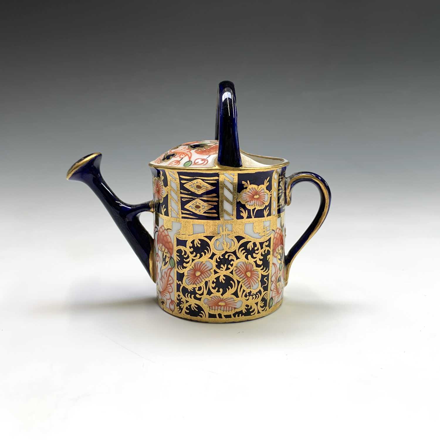 A Royal Crown Derby model of a watering can. Height 7cm.