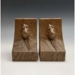 A pair of Robert Thompson of Kilburn 'Mouseman' bookends of typical form, with adzed finish and