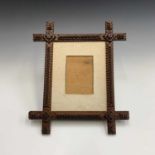 A Tramp art picture frame, circa 1900, with typical zig-zag decoration, 39 X 33.5cm maximum.