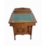 A Late Victorian mahogany davenport, the raised back fitted with stationary dividers and inkwells