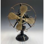 A vintage cast metal and brass directional electric table top fan, with carrying handle, height