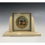 A 1920s ivory and gilt metal Swiss boudoir timepiece, the dial painted with a lute player serenading