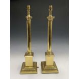 A pair of brass effect corinthian column table lamps. Height 64cm overall.