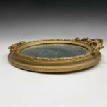 A late 19th century oval gilt small wall mirror, height 43cm.
