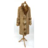 A Fox fur trimmed fur coat. Good clean condition, beautifully soft.