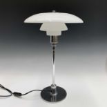 A Poul Henningsen for Louis Poulsen PH 3/2 chrome table lamp with three opaque glass shades.