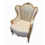 A French style gilt decorated armchair, of Louis XVI style, with machine tapestry back, shell and