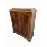 A George III style mahogany side cabinet, early 20th century, with a pair of panelled doors, on