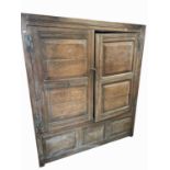 A wonderful late 17th, early 18th century country made oak hall cupboard, each door with two fielded