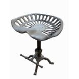 An industrial type stool with tractor style seat. Height 64cm.