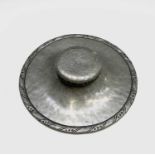 A Hugh Wallis Arts and Crafts pewter shallow ink well, of circular form, with engraved border,