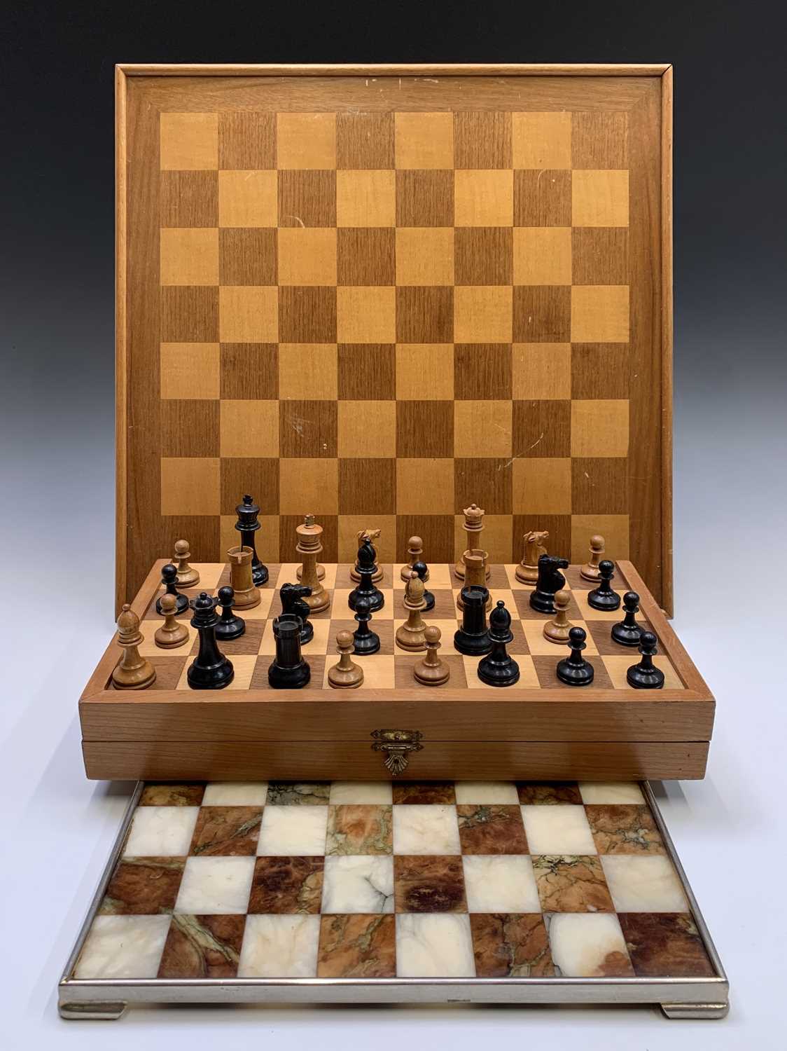 A Staunton type boxwood and ebony chess set, the Kings height 7.5cm, together with a similar set, in