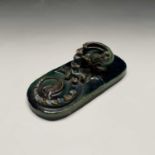 A C H Brannam Barum desk weight moulded in relief with a dragon type creature with scaly back and