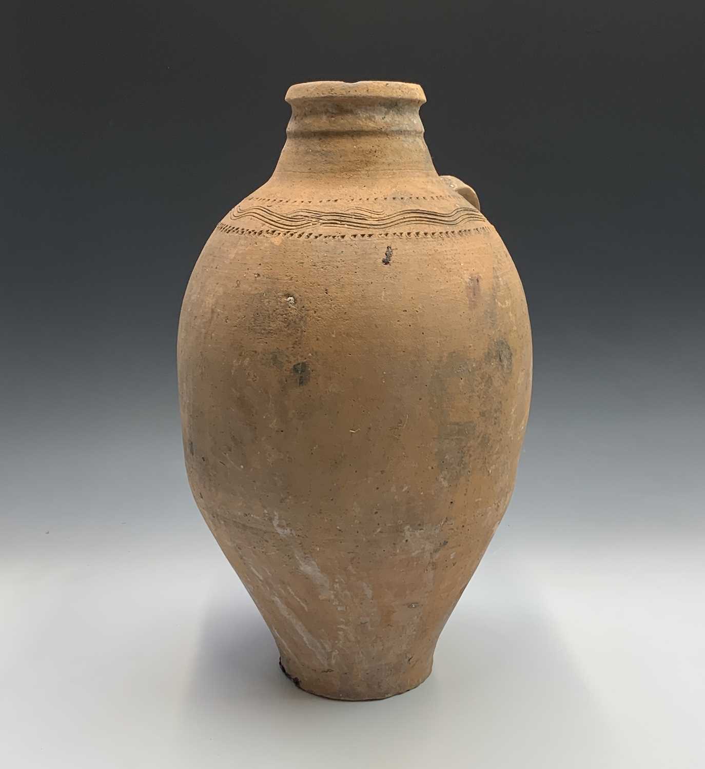 A terracotta vessel with twin handles, incised and impressed banded decoration. Height 55cm. - Image 3 of 4