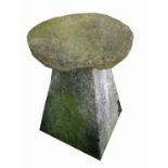 A sandstone staddle stone, raised on an angled support. Height 76cm overall.