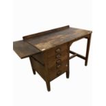 An early 20th century oak single pedestal desk, with end flap and fitted five drawers, the copper