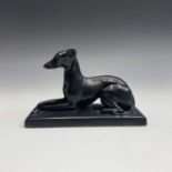 A Mintons matt black glazed figure of a recumbent greyhound, circa 1900, length 19cm.