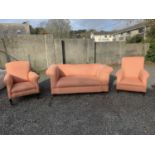 A Victorian Chesterfield sofa, with reclining arm, a matching Victorian armchair and an Edwardian