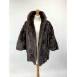 A fur coat, (probably mink) by Griffin & Spalding furriers of Nottingham, 1950s style, 3/4 length