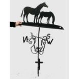 A wrought metal weather vane surmounted by a mare and foal. Height 154cm.