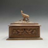 A Black Forest carved linden wood jewellery casket, circa 1900, mounted with an ibex, width 19cm and