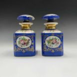 A pair of 19th century French porcelain scent bottles with stoppers, gilded and with floral