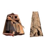 A 1940s folding boat, with pair of oars stamped Proud, in original canvas case. Length 227cm,