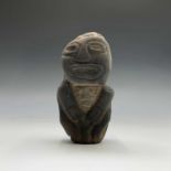 A Pre Columbian carved stone idol figure, South America, carved with his hands on his stomach and