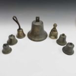 A cast brass bell, 20cm diameter, together with five assorted handbells and a crinoline lady bell (
