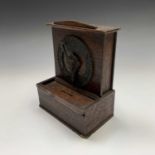 An unusual oak money box, circa 1920, with patent cast clock dial operated combination lock,