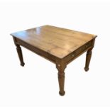 A Victorian pine kitchen table,the triple planked top above a single frieze drawer, on turned