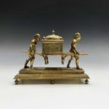 An unusual Continental brass inkwell, circa 1900, modelled as two Oriental figures supporting the