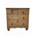 A pine chest of drawers, early 20th century, with two short and two long drawers, on bun feet,