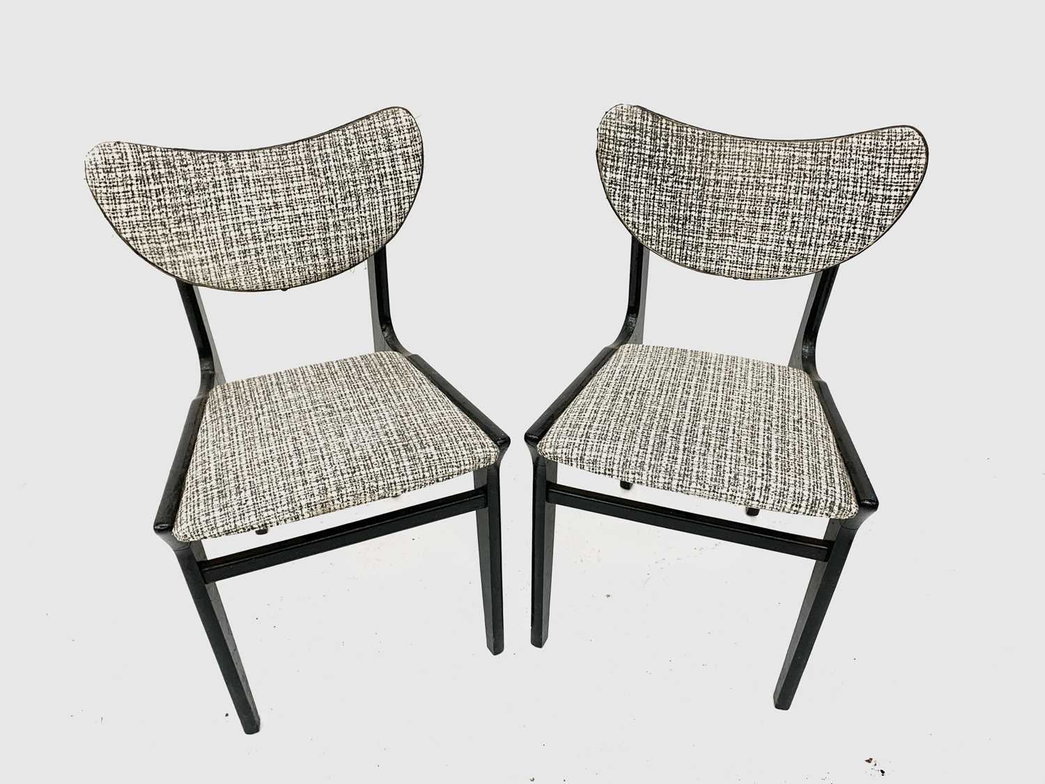 A pair of 1950's black painted butterfly back chairs.