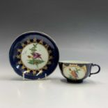 A rare Worcester teacup and saucer, circa 1770, painted in polychrome enamels with an exotic bird
