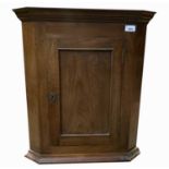 A small mahogany hanging corner cupboard, early 19th century, height 63.5cm, width 53cm.